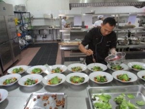 A chef and his team are preparing the test lunch at ms nieuw jakarta