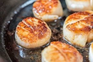 The photo of scallops are being cooked