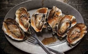 A plate of cooked oysters, one of the best recipe to guide you understand about the taste of oyster