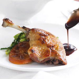 A photo of sous-vide confit duck legs (2pcs) + sauce by chef camille